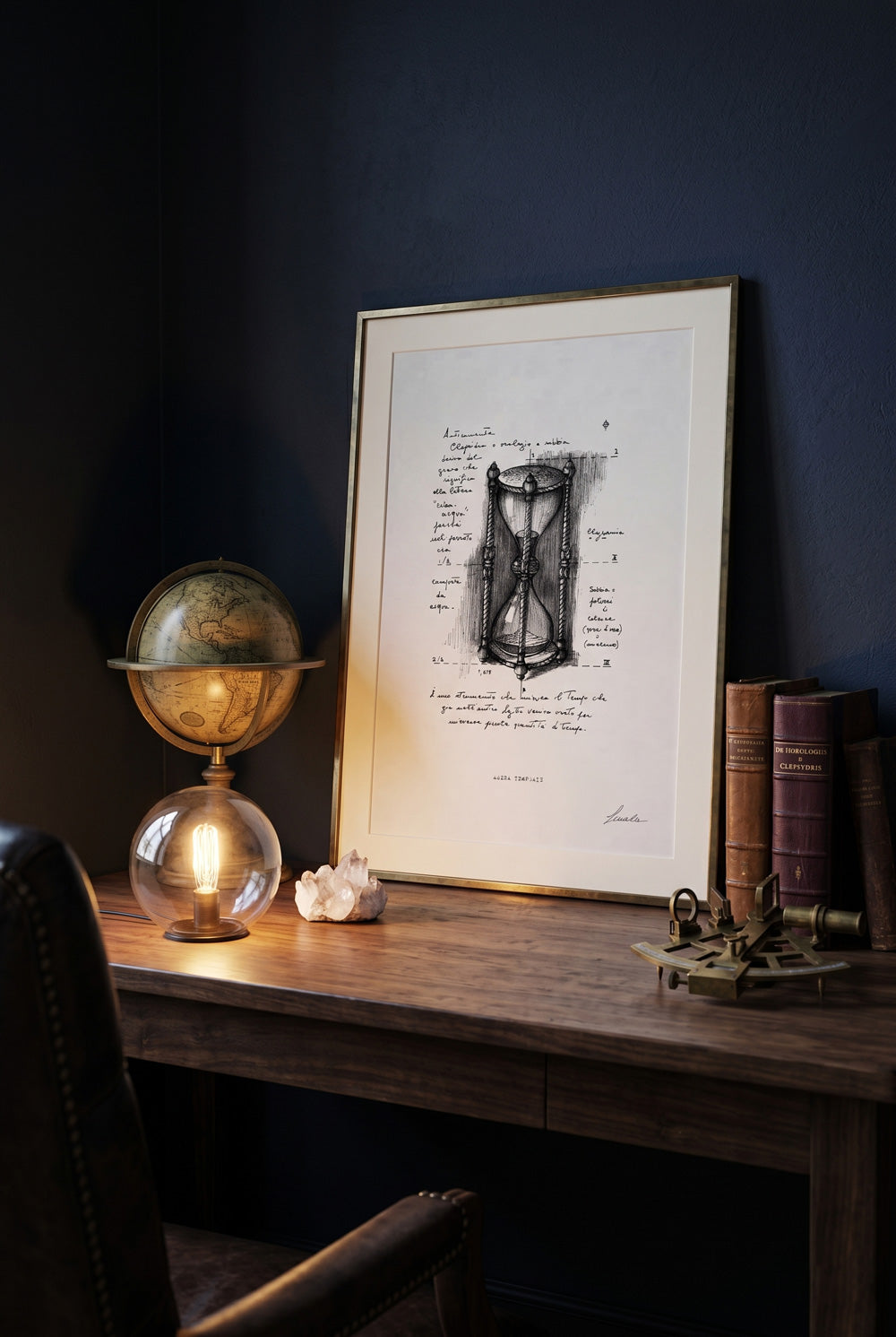 Framed print Arena Temporis on a wooden desk next to a vintage globe lamp - fine art wall art | Lorenzo Caia